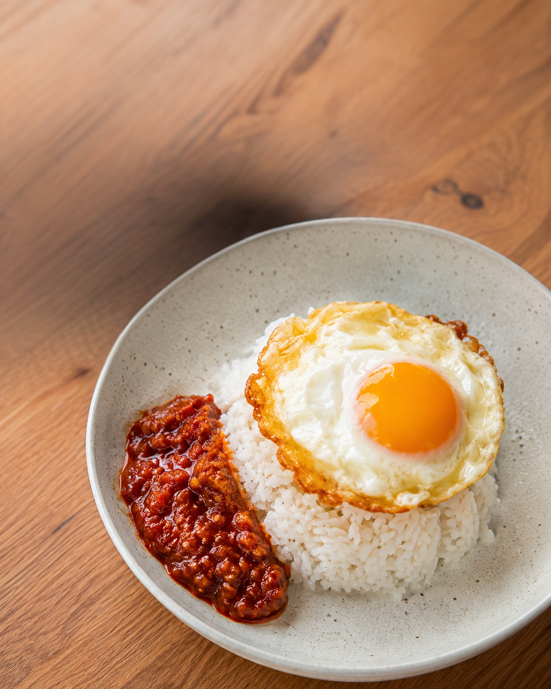 Fried egg over rice with a spoonful of KneadSG Sambal Belacan
